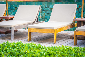Beautiful tropical beach sea and ocean with coconut palm tree  and umbrella and chair on blue sky and white cloud