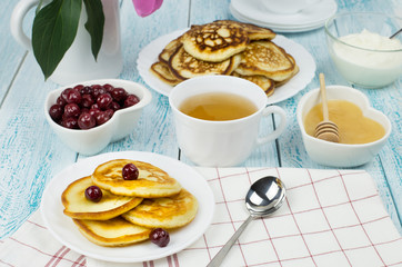 Delicious Breakfast, pancakes with sour cream, honey and cherries.