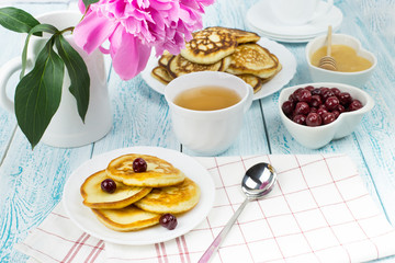 Delicious Breakfast, pancakes with sour cream, honey and cherries.