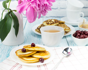 Delicious Breakfast, pancakes with sour cream, honey and cherries.