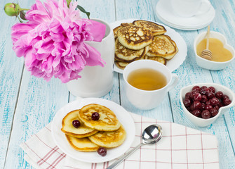 Delicious Breakfast, pancakes with sour cream, honey and cherries.