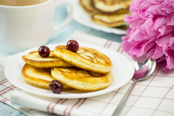 Delicious Breakfast, pancakes with sour cream, honey and cherries.