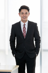 Businessman standing and crossed his arm..