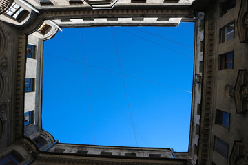 View to the piece of blue sky from the bottom of the well yard in Saint Petersburg, Russia