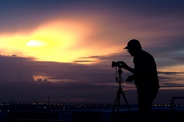 silhouette of photographer at sunset