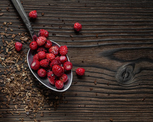 wild strawberries on wooden plate