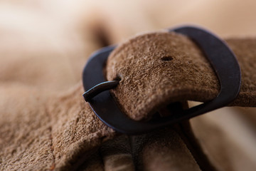 Fastened buckle. Buckle section of a leather bag or case. Extremely shallow depth of focus. Focus...