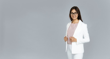 Confident smiling indian young elegant businesswoman wear suit glasses looking at camera isolated...