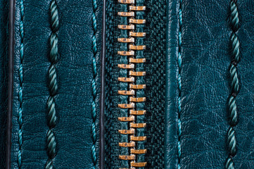 Zipper clasp with lock on the bag blue color, closeup