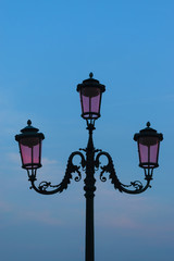 Fototapeta na wymiar Pink street lantern in Venice, Italy