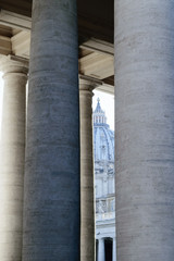 The St. Peters basilica visible through pillars in Vatican