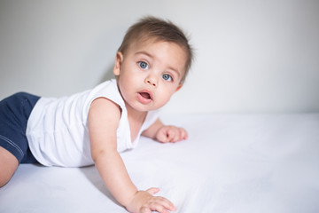 Blue-eyed baby in bed