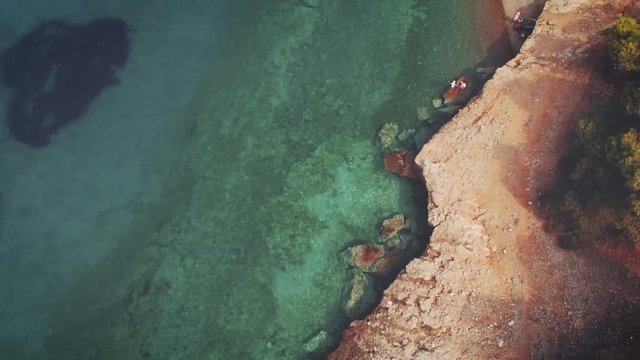 aerial footage of an exotic beach with crystal clear turquoise waters in Greece at summer 2