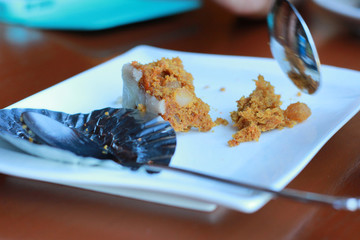 The cake bakery on the plate was eaten and almost consumed.