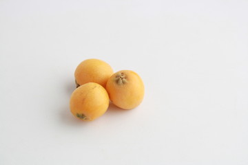 delicious yellow medlar fruit with white background