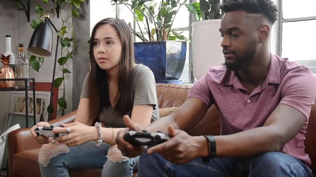 Sliding Shot Of A Couple Playing Video Games At Home