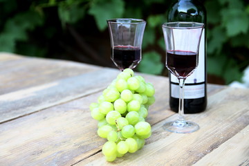 Valentine's Day drink of red wine in glass with grapes on a table no people stock photo