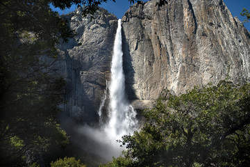 Fototapeta na wymiar Beautiful spring full-flowing waterfall in Yosemite National Park, California, USA