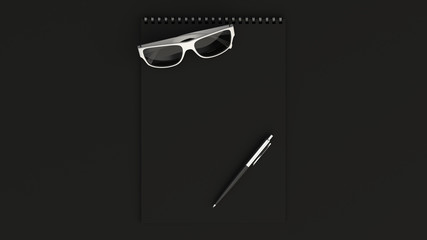 Notebook with sunglasses and pen