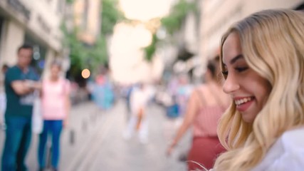 Slow,motion:Attractive young beautiful girl waves Turkish flag and pulls arm of her boyfriend at narrow street in Istanbul,Turkey