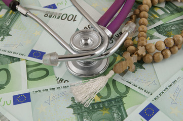 Stethoscope and rosary money background