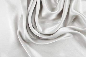 Naklejka na ściany i meble The texture of the satin fabric of white color for the background