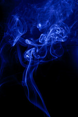 Fototapeta premium Blue smoke on a black backgroug.