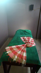 Green massage table with towel. A place to relax in the modern Wellness centre.