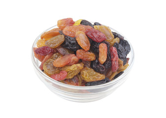 Raisins in glass bowl isolated on white background