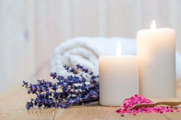 Obraz na płótnie Canvas closeup of sea salt with lavender and burning candles spa procedures