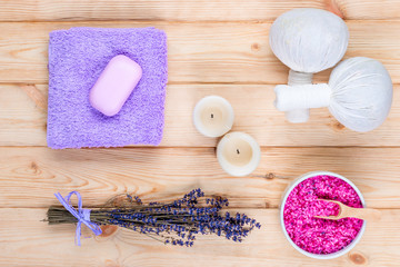Fototapeta na wymiar lavender, candles and herbal massage bags top view objects for spa treatment