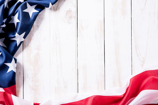 Top view of Flag of the United States of America on white wooden background. Independence Day USA, Memorial.