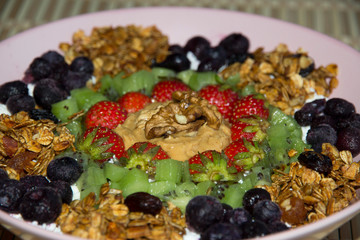 Cottage cheese with granola, kiwi, strawberries, blueberries