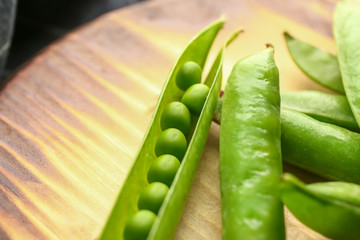Tasty fresh peas on wooden board, closeup