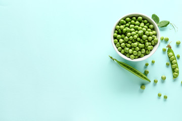Bowl with tasty fresh peas on color background