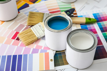 Cans of paint with brushes and palette samples