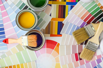 Cans of paint with brushes and palette samples