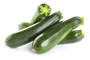Fresh zucchini squashes on white background