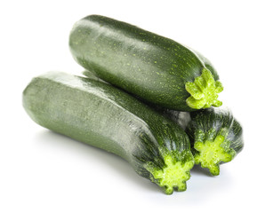 Fresh zucchini squashes on white background