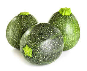 Fresh zucchini squashes on white background