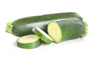 Fresh zucchini squashes on white background