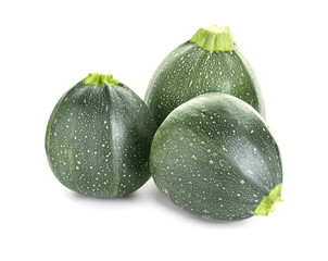Fresh zucchini squashes on white background