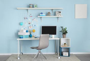 Workplace with mood board and computer in modern room