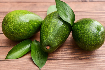 Fresh ripe avocados on wooden background