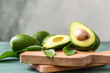 Boards with fresh ripe avocados on table