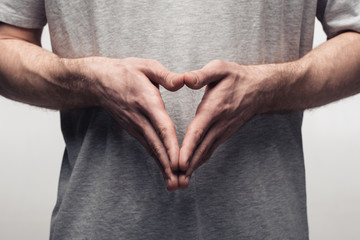 partial view of man showing steeple gesture while using body language isolated on grey, human emotion and expression concept