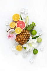 Summer composition with different fruits, flowers and ice cubes on white background