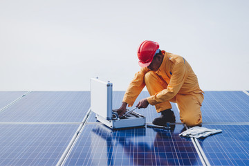 Expertise service team working on measuring efficiency of operation and maintenance at solar plant; engineer working on checking and maintenance electrical equipment