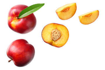 Nectarine with green leaf and slices isolated on white background. top view