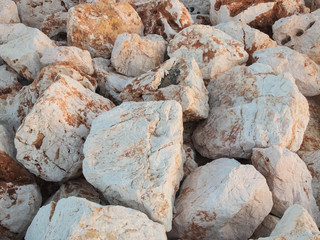 Large marble boulders of sea embankment in the evening light